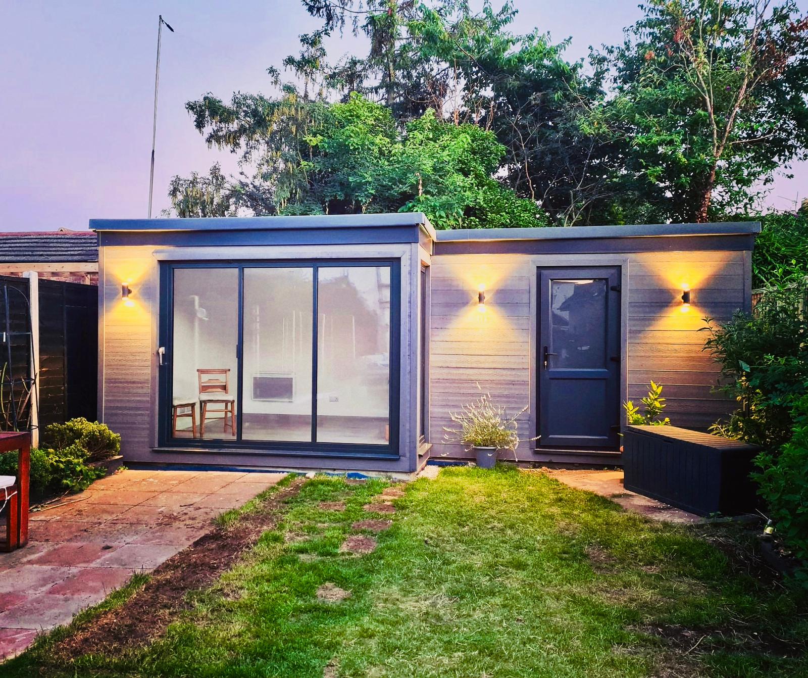 Garden room and storage with warm exterior lighting